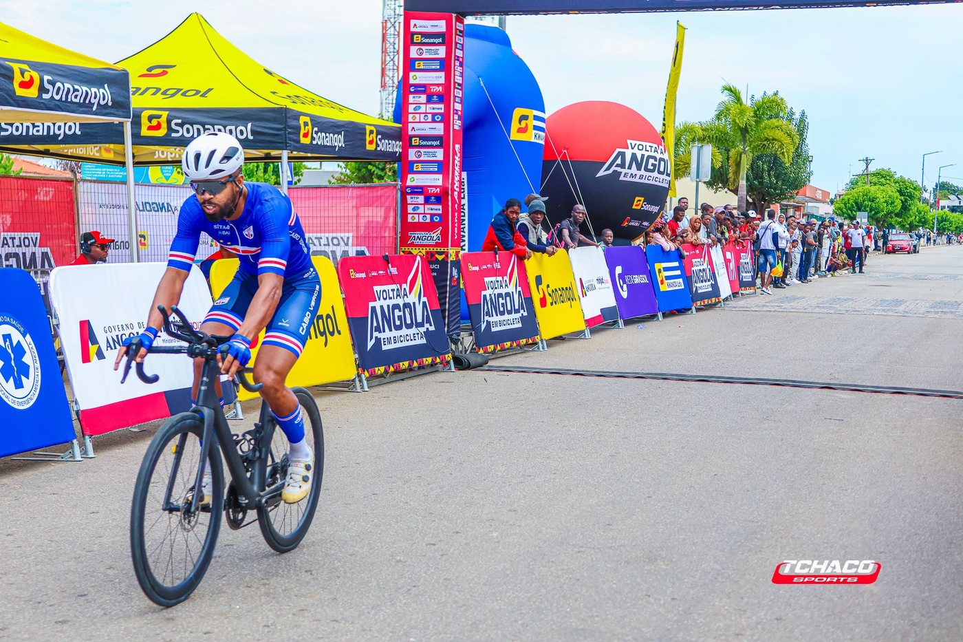 Atleta da selecção de Cabo Verde em prova, nas ruas do Cuito, junto às barreiras de publicidade